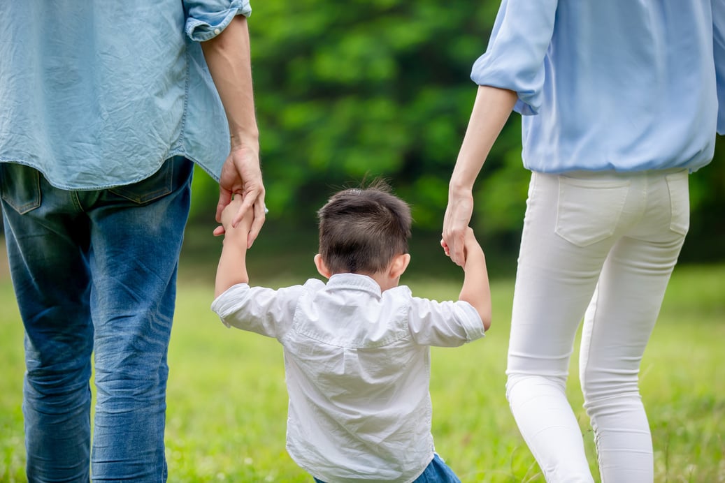 Young Parents Walking with Kid